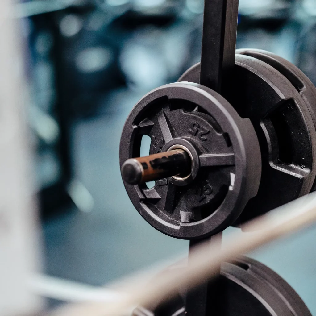 Close-up of 25 lb weight plates on a barbell at Trinity Center gym.