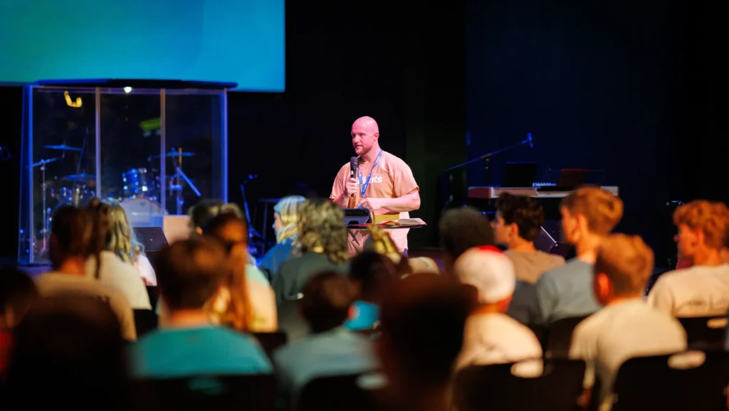 Pastor Caleb engaging TBC Students during worship at Trinity Baptist Church.