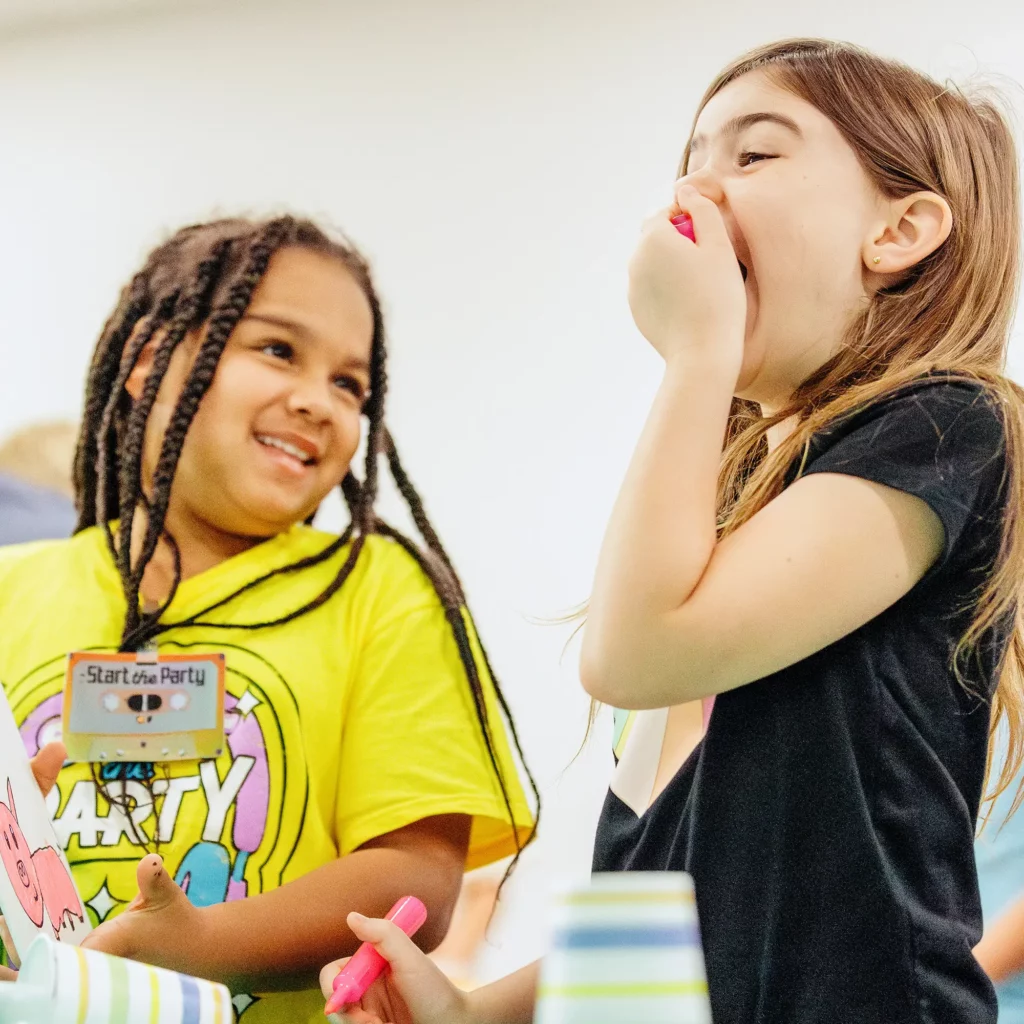 Girls sharing a fun moment during Vacation Bible School at Trinity Baptist