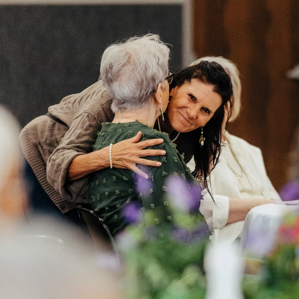 Women sharing conversation and encouragement at a WINGS event.