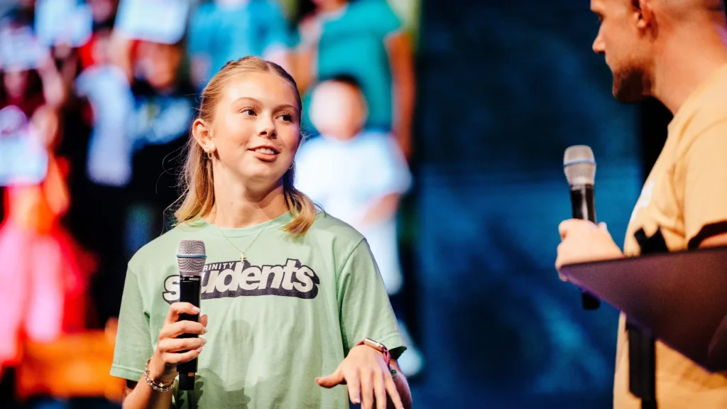 Trinity student shares mission experience on stage during church conference