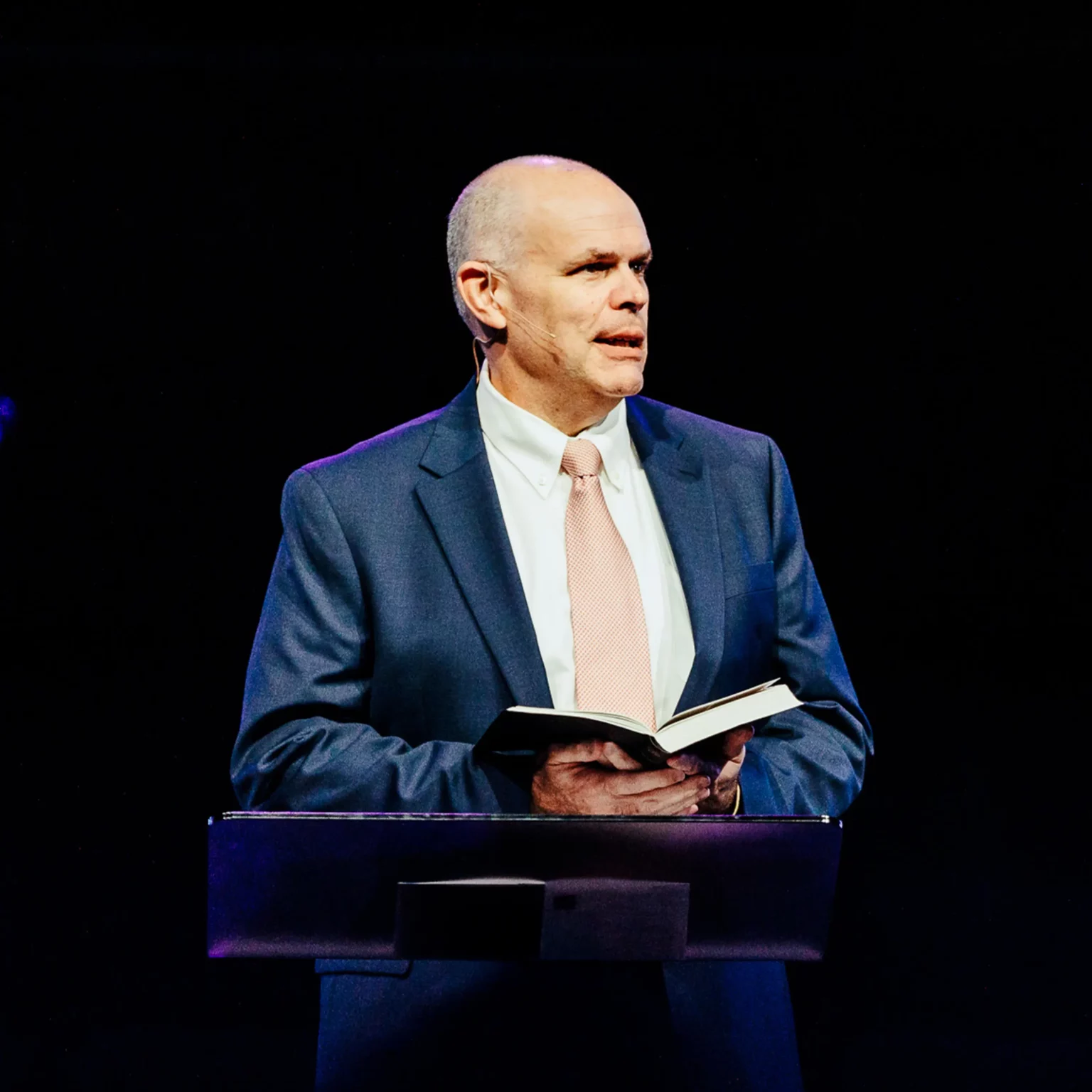 Dr. David Rose preaching from the pulpit during Easter sermon at Trinity Baptist Church