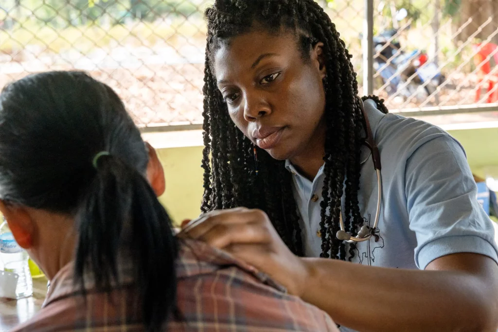 A medical professional provides medical care during mission trip in Kenya