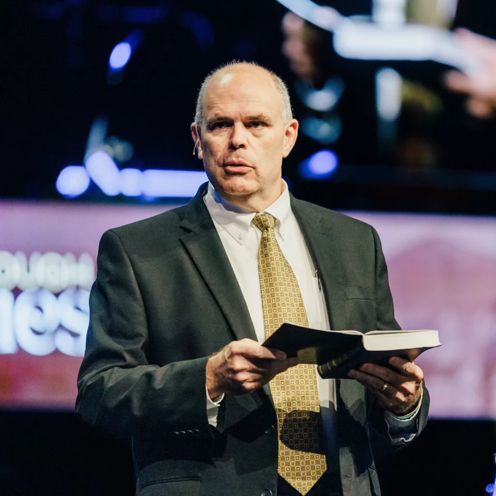 Pastor David Rose holding a Bible during Sunday sermon at Trinity Baptist.