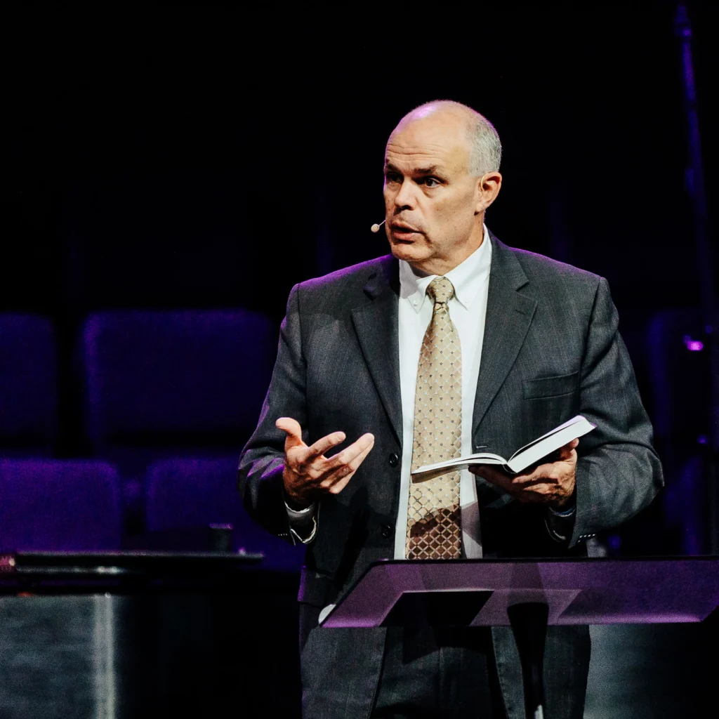 Pastor David Rose speaking from the pulpit during sermon on covenant faithfulness.