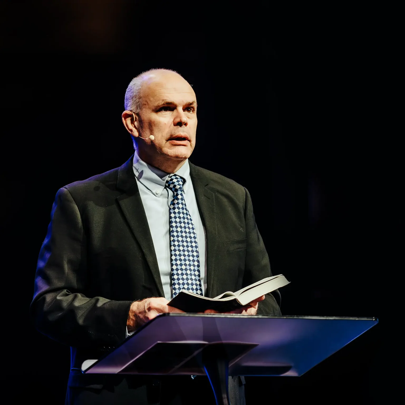 Pastor David Rose teaching at Trinity Baptist Church with an open Bible.