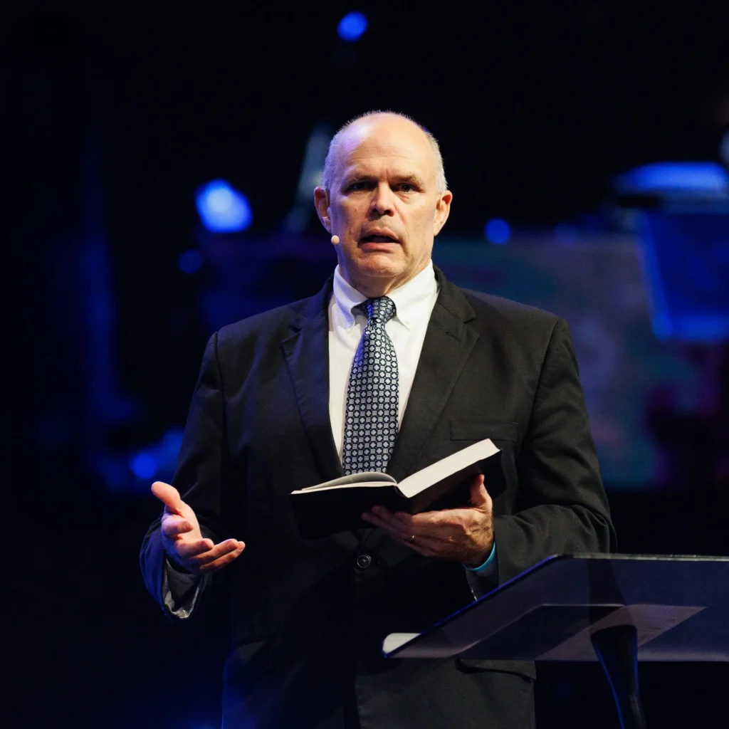 Pastor David Rose preaching with open Bible at Trinity Baptist Church in Lake Charles.