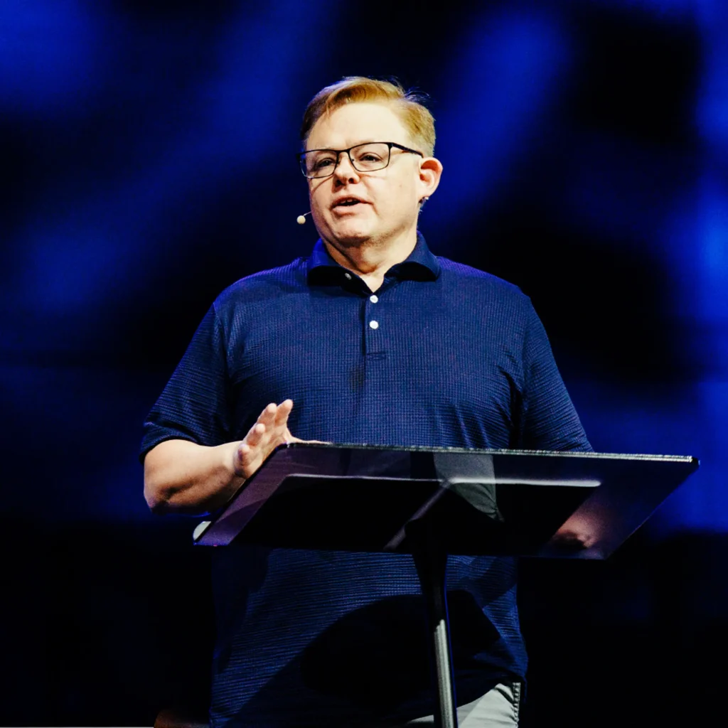 David Cowan speaking at a podium during a sermon at Trinity Baptist Church in Lake Charles.